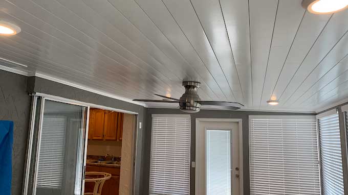 Ceiling fan installation on a painted shiplap ceiling