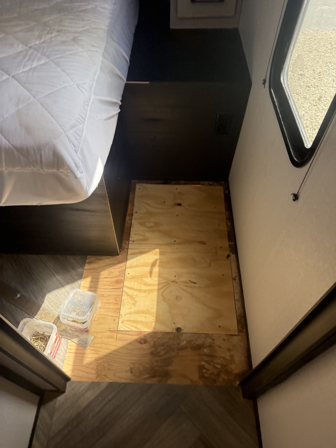 Plywood patch installed beside the bed.